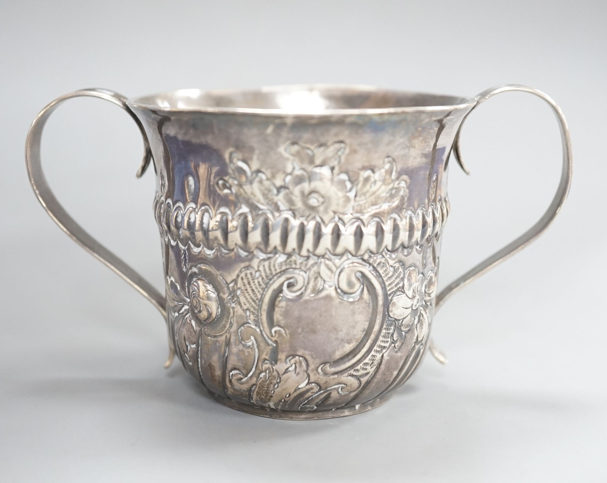 A George III embossed silver porringer, FM, London, 1766, 64mm, 79 grams.